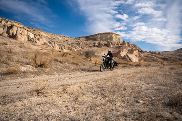 Woman riding Royal Enfield Himalayan 411 motorcycle in Cappadocia, Turkey