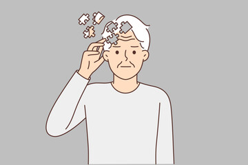 Elderly man with puzzles near head, symbolizing dementia, suffers from memory problems or alzheimer