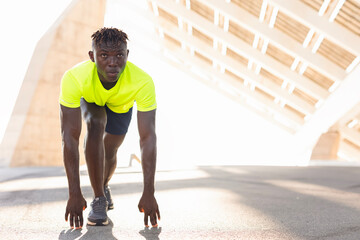 Fototapeta premium Close up of male athlete getting ready to start runningon track. Man running.