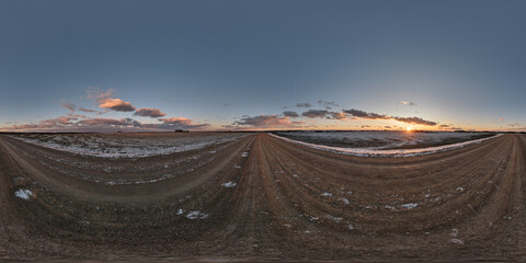 winter 360 hdri panorama on gravel road with evening clouds on blue sky before sunset in...