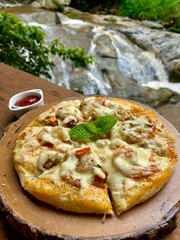 pizza with ham and cheese on wooden board