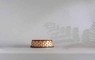 Podium and fern shadow. Product display on a gray background. Mockup for product branding, presentation. Background for products, cosmetics, jewelry.