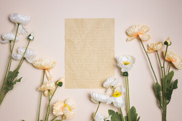 A brown paper with flowers over the pink background.