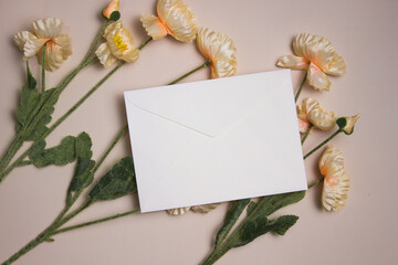 A white envelope with flowers over the light background. 