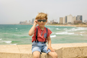 European tourist family with children, visiting Tel Aviv, Israel, enjoying day walk