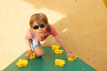 Happy children, boys, playing on playground in Tel Aviv, israel on hot summer day