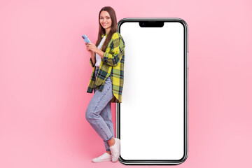 Full body photo of attractive nice lady use telephone empty space big poster isolated on pink color background