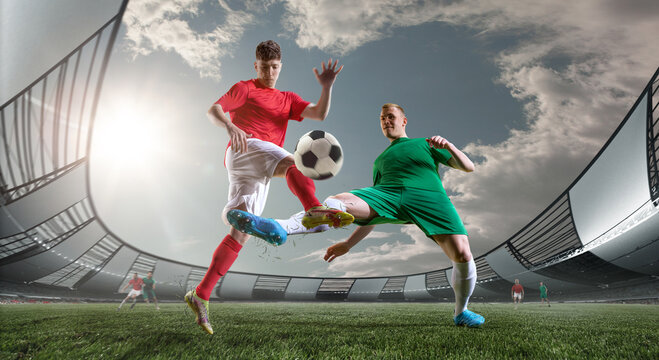 Dynamic image of two competitive men, football players in motions, playing on 3D arena outdoors. During match. Concept of professional sport, championship, game, achievement, competition
