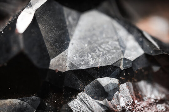 Metal rock texture. Close up of a raw hematite stone. Shiny mineral with an abstract pattern.	