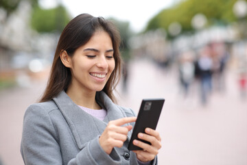 Woman using cell phone in street