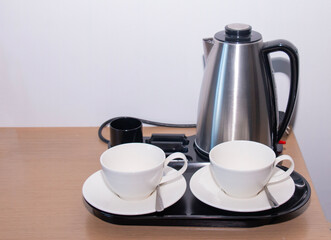 coffee pot with cups on a tray, morning coffee drinking