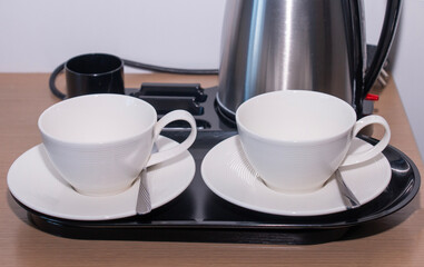 coffee pot with cups on a tray, morning coffee drinking