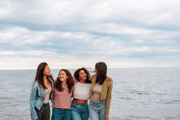 Group portrait of four young women enjoying beach