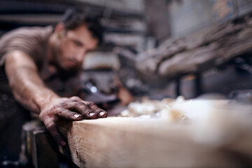 Craftsman chiseling wood in workshop - obrazy, fototapety, plakaty