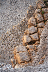 Natural rock texture of a colorful rock formations in Portio beach in Cantabria, north of Spain.
