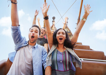 Portrait enthusiastic friends cheering on amusement park ride