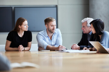 Business people discussing paperwork in meeting