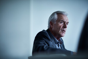 Fototapeta premium Serious senior businessman listening in meeting
