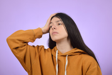 upset young woman holding her head, headache