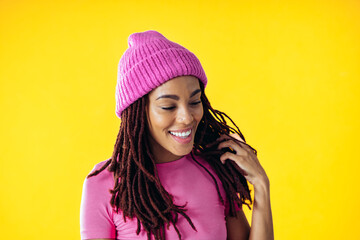 Woman posing on colored backgrounds in studio wearing trendy clothes