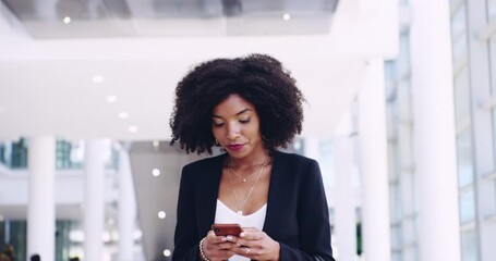 Phone, communication and a business woman walking in the office for professional work. Portrait, thinking and smile with a happy young black female employee typing a text message in the workplace - Powered by Adobe