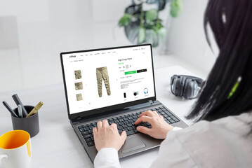 Woman browsing online for cargo pants, exploring stylish options and finding the perfect fit for...