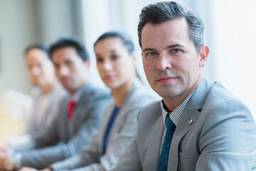 Fototapeta premium Portrait of confident businessman and colleagues in a row