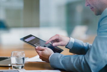 Businessman using digital tablet in office