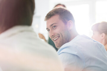 Smiling businessman listening in meeting