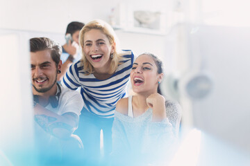 Creative business people laughing at computer in office