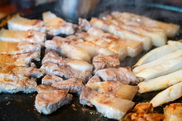 Fresh and delicious iron pan-fried black pork meal in Jeju Korean restaurant.