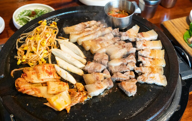 Fresh and delicious iron pan-fried black pork meal in Jeju Korean restaurant.