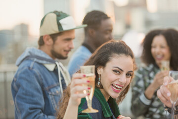 Portrait enthusiastic young woman drinking champagne at party