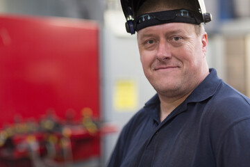 Portrait confident welder in steel factory