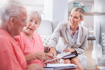 Financial advisor showing digital tablet to senior couple