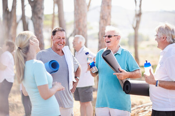 Yoga instructor talking to senior men after class in park