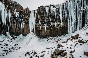 Icicle formations hanging over craggy cliff, Iceland