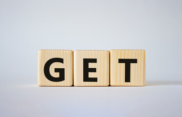 GET symbol. Concept word GET on wooden cubes. Beautiful white background. Business and GET concept....