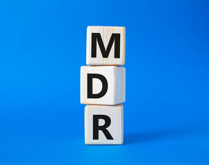 BPM - Business Process Management symbol. Wooden cubes with words BPM. Beautiful blue background....