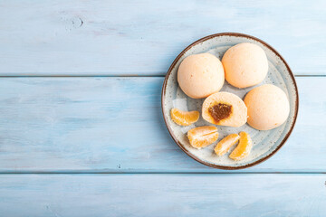 Japanese rice sweet buns mochi filled with tangerine jam on a blue wooden. top view, copy space.
