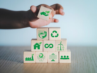 Children's hands and imagination on wooden blocks The concept of renewable energy, family, love of nature, environmental technology. green technology