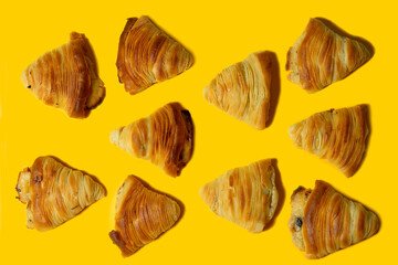 Puff pastry in the shape of a shell Sfogliatelle- traditional Neapolitan sweets made of puff pastry with a filling of sweet ricotta cheese. Italian desserts on a bright yellow background. tasty.banner