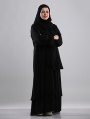 saudi arabian woman lady standing wearing  hijaab looking infront side view