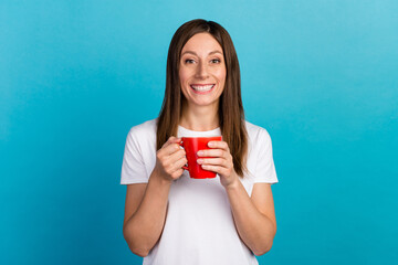 Close-up portrait of nice girl holding hands drinking latte isolated on bight vibrant blue color background