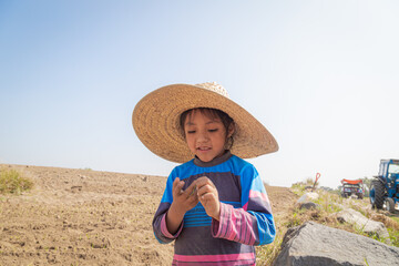 portrait of a little girl with an adorable farmer's hat 