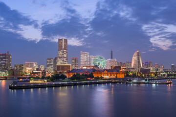 Yokohama, Japan city skyline from the bay at twilight.