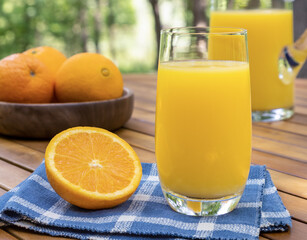 Glass of orange juice outdoors on a table