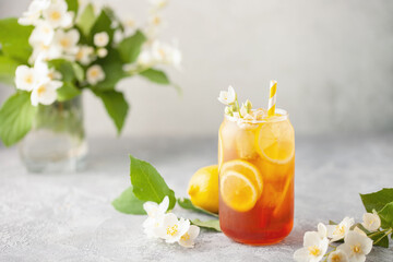 Lemon jasmine iced tea in a glass  on a gray background