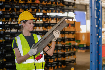 Portrait of female storage worker at Worker Holding Stock Inside Warehouse.