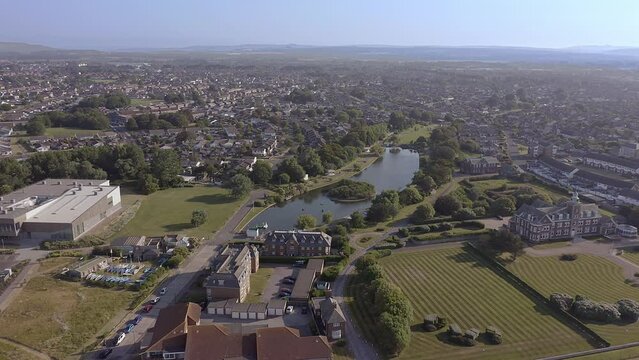Mewsbrook Park on the border between Littlehampton and Rustington, a popular park with Art Deco shelters and a boating and wildlife lake, aerial footage.